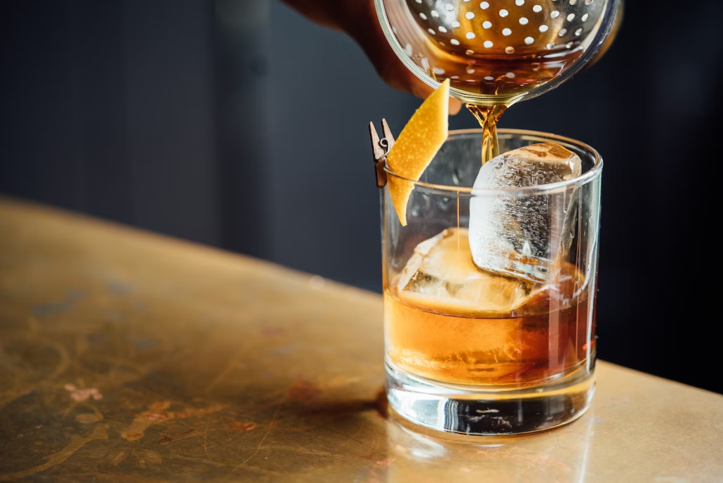 A close-up shot of a half-filled whiskey glass