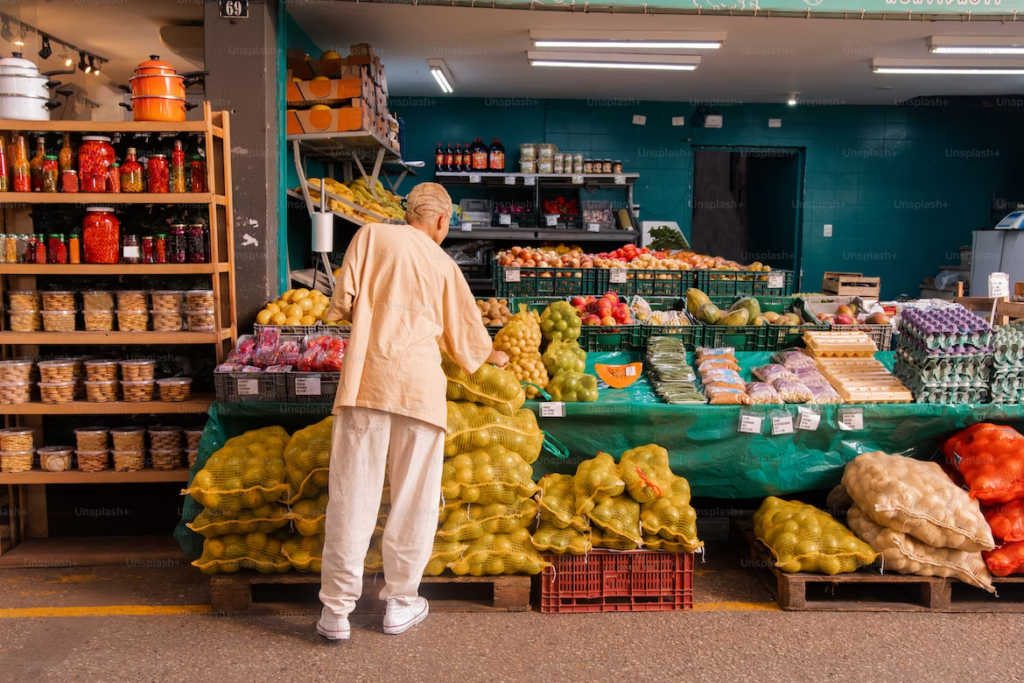 Image of a person selecting produce at a local convenience store.