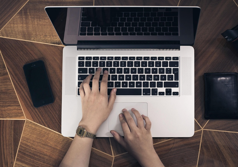 A person typing on a laptop.