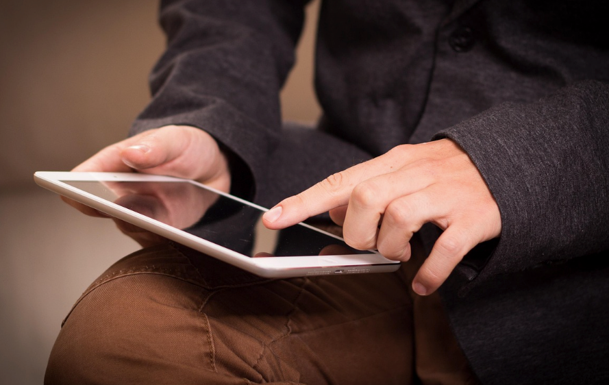 A person holding a tablet.