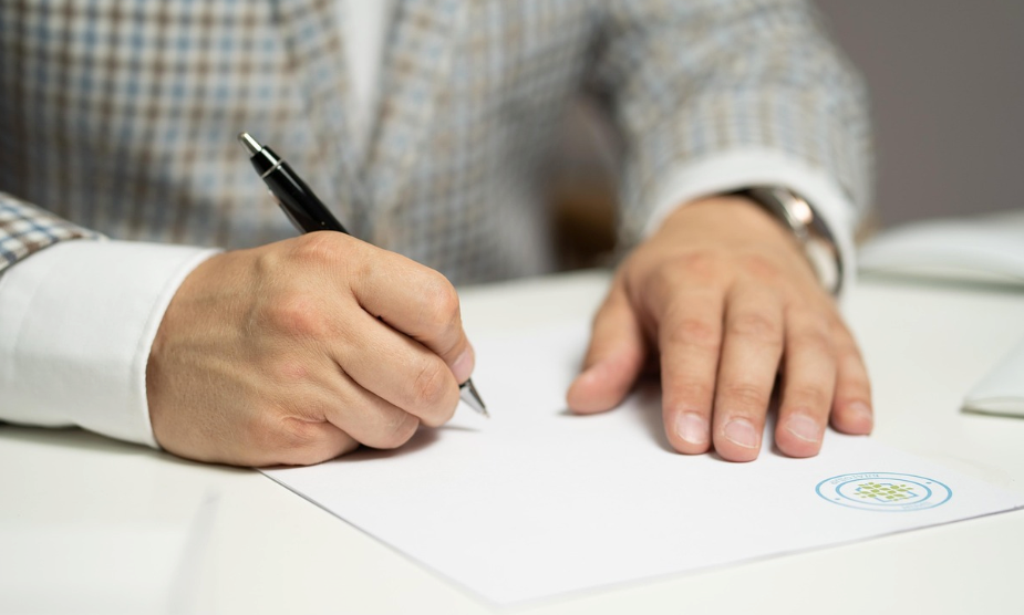 A person writing on a piece of paper.