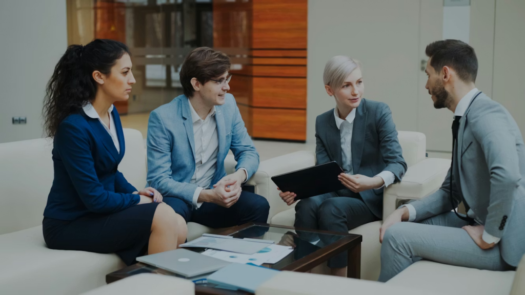 A group of financial professionals discussing a press release in an office setting.
